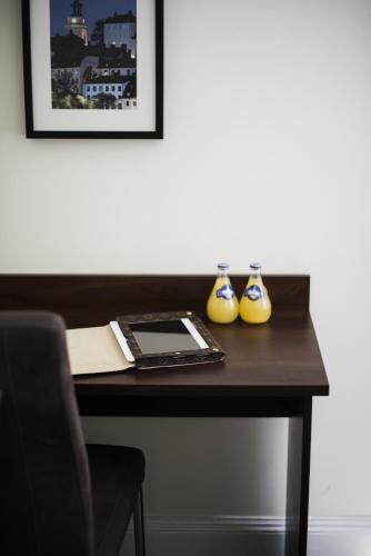 a desk with two vases on top of it at Castle House Inn in Stockholm