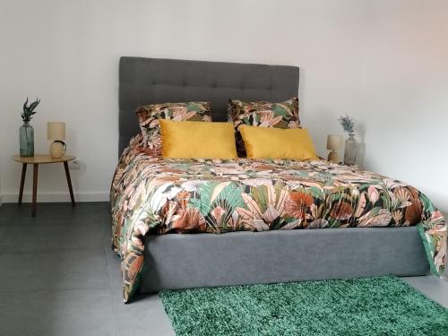 a bed with two pillows on it in a bedroom at São Miguel Apart. in Vila Franca do Campo