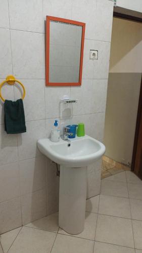 a bathroom with a white sink and a mirror at Casa Tota in Assomada