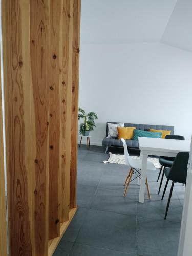 a living room with a white table and a couch at São Miguel Apart. in Vila Franca do Campo