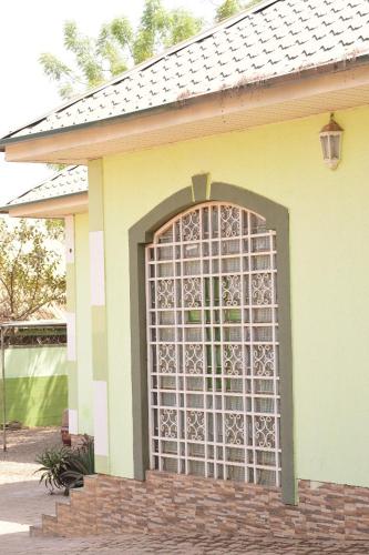 a house with a gate on the side of it at Royale Suites and Apartment in Abuja