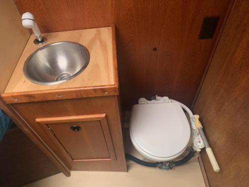 a small bathroom with a sink and a toilet at Sailboat Experience in Annapolis in Annapolis