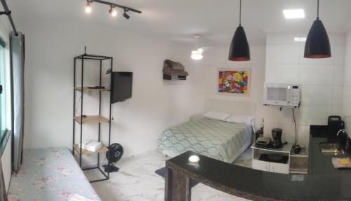 a bedroom with a bed and a desk in it at Casa Nova Centro de Penedo in Penedo