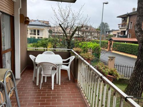 a patio with a table and chairs on a balcony at La terrazza con le biciclette a due passi dal lago in Arona