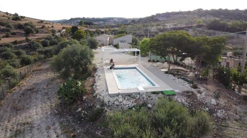 an overhead view of a person standing next to a swimming pool at Casa Giufà B&B in Chiaramonte Gulfi