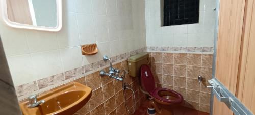 a bathroom with a toilet and a sink at NUNES SEA WALK in Candolim