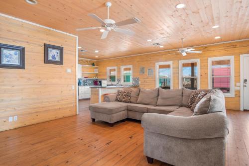 a living room with a couch and a ceiling fan at Tequila Sunrise in Port Aransas