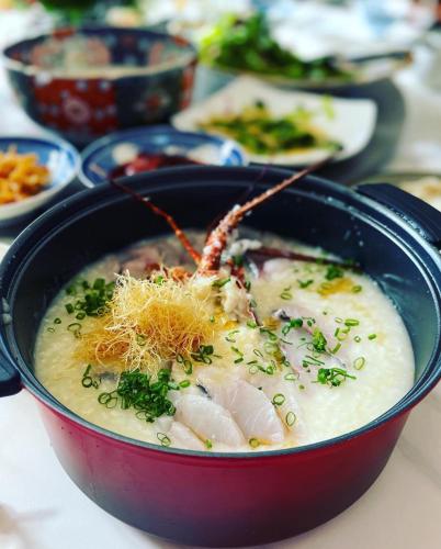 a bowl of soup with shrimp and other foods at Grand Maison W 館山美食倶楽部 in Tateyama