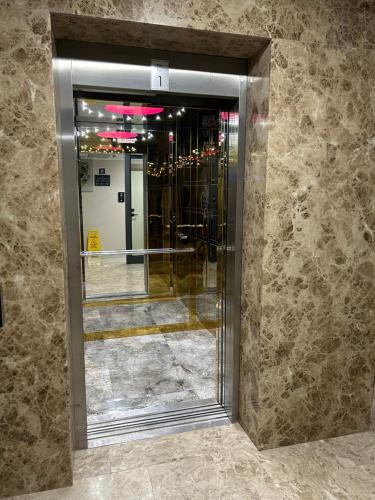 a glass door in a building with a mirror at 01 Nova Otel in Didim