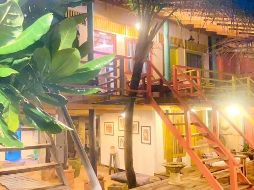 a tree house in a room with a palm tree at Amaranthe Beach Cabanas in Galle