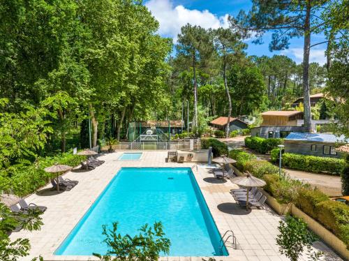 an image of a swimming pool at a house at Camping-Village Vacances Les deux Étangs in Seignosse