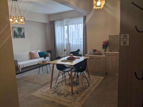 a kitchen and living room with a table and chairs at Aristo Central Apartments in Ioannina