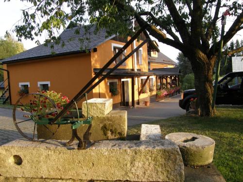 a statue of a swing on some rocks in front of a building at Penzion u Petra in Jeseník