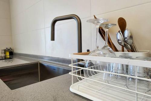 a kitchen counter with a sink and a dish drying rack at Mipoblues Haeundae in Busan