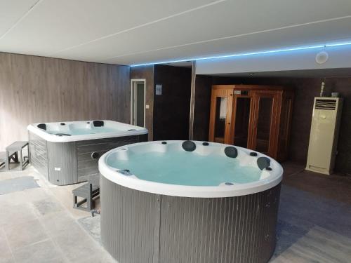 a large bathroom with a jacuzzi tub at Futurcasa Casa rural Spa y cine in La Felipa