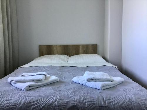 - 2 serviettes assises au-dessus d'un lit dans l'établissement Apartament 'Wszędzie Blisko', à Kołobrzeg