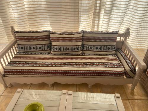 a couch sitting in front of a window at RESIDENCE DAR YASMINa in Mezraya