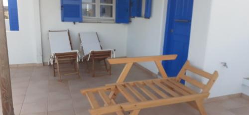 a room with chairs and a table and a bench at Hotel Posidonion in Koufonisia