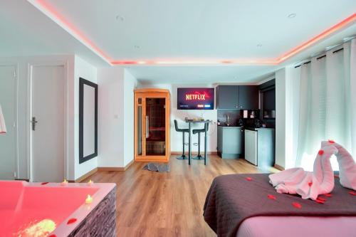a bedroom with two pink flamingos sitting on a bed at LE COCON- Jacuzzi & Sauna privés By SweetDreams in Le Cannet