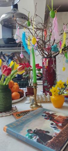 a table with a candle and flowers on it at Cheltenham race accommodation for Cheltenham Festival in Southam