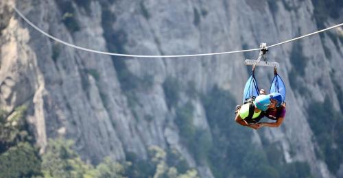 a person on a zip line in front of a mountain at Casa Vacanze Sud e Magia in Castelmezzano