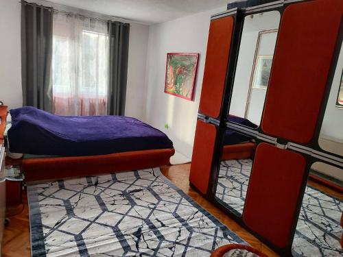 a room with two bunk beds and a rug at Villa Artemida apartman in Kulen Vakuf