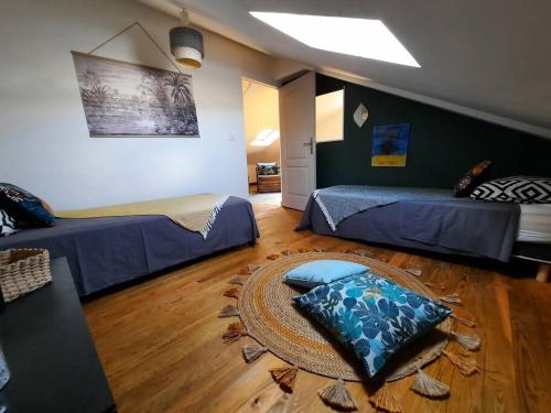 a room with two beds and a table in it at Villa Pierre Mandarine, dans l'ouest in Saint-Gilles-les Hauts