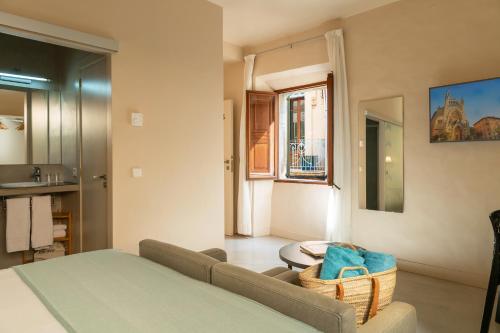 a living room with a couch and a window at SólleRooms in Sóller