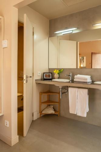 a bathroom with a sink and a counter with towels at SólleRooms in Sóller
