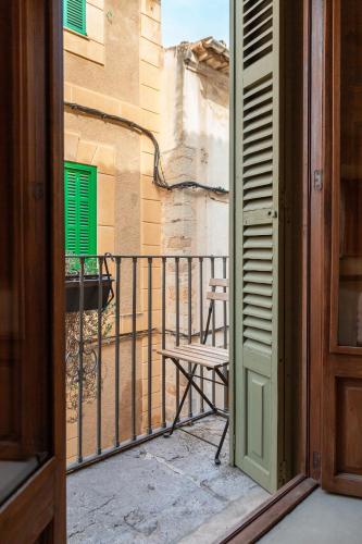 an open door to a balcony with a chair at SólleRooms in Sóller
