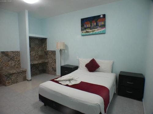 a bedroom with a bed and a fireplace at Hotel Awazul Bacalar in Bacalar
