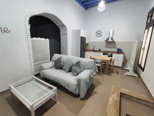 uma sala de estar com um sofá e uma mesa em Loft del Capataz em San Fernando