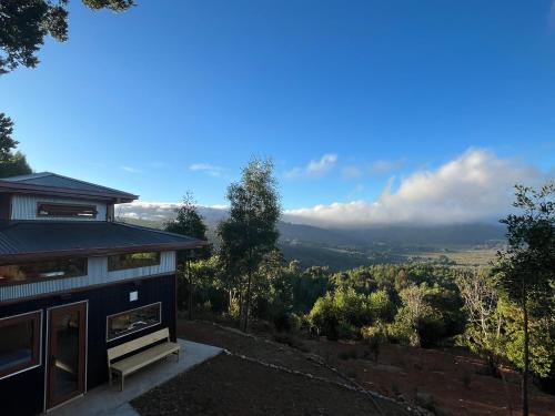 a house on a hill with a view at Cabañas japonesas en el bosque KURO y AKA in Valdivia