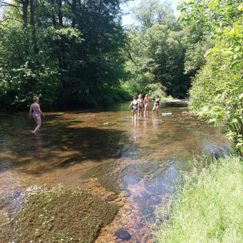 a group of people standing in a river at Willa Marianna in Lądek-Zdrój