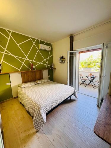 a bedroom with a bed with a green wall at l'alba sullo jonio in Taranto