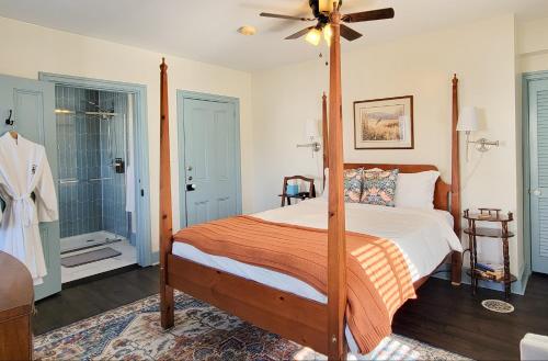 a bedroom with a canopy bed and a shower at Pheasant Field Bed and Breakfast in Carlisle