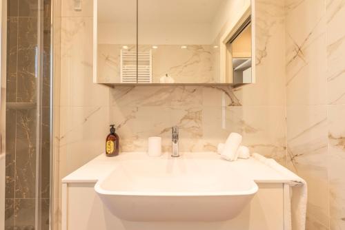 a bathroom with a white sink and a shower at TENUTA FOGLIANI Resort & Natural Spa in Visciano