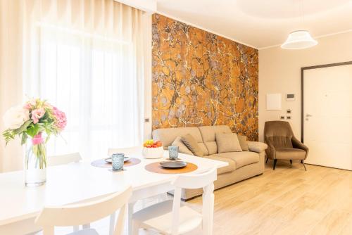 a living room with a white table and a couch at TENUTA FOGLIANI Resort & Natural Spa in Visciano