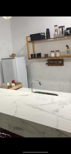 a bathroom counter with a sink and a faucet at Green House in Corumbau