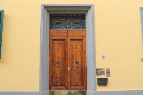 a wooden door on the side of a building at B&B Calcio Storico in Florence