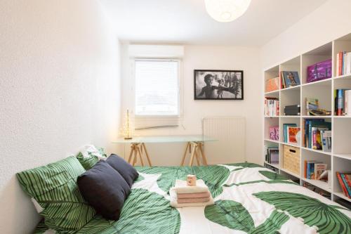 een slaapkamer met een bed en een boekenplank bij résidence privée YourHostHelper in Onet le Château