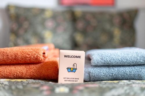 a pile of towels sitting next to a pile of towels at résidence privée YourHostHelper in Onet le Château