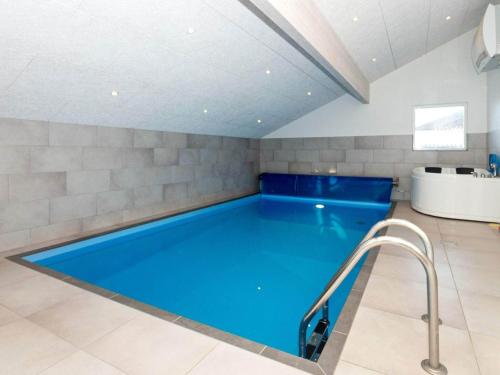 a large swimming pool in a room with at 14 person holiday home in L gst r in Trend