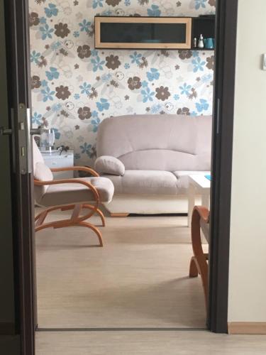 a living room with a couch and a chair at PATIO dom gościnny in Łukęcin