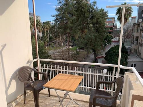 a wooden table and two chairs on a balcony at LuxuryHome in Seyhan