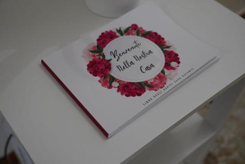 a heart shaped book on a table with a flower wreath at Il Posto per Te in Turi