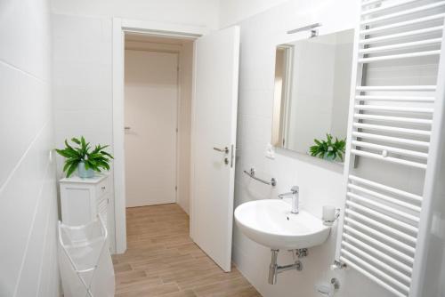 a white bathroom with a sink and a mirror at Il Posto per Te in Turi