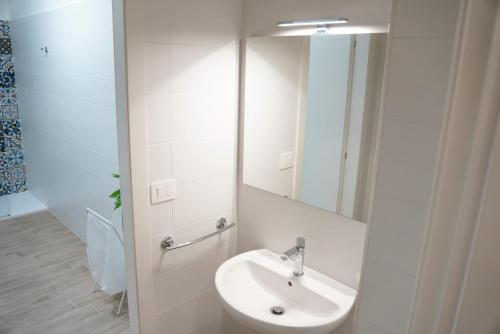 a white bathroom with a sink and a mirror at Il Posto per Te in Turi