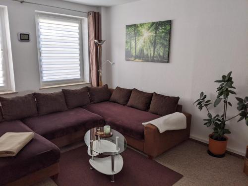a living room with a couch and a table at Ferienwohnung Am Ueckerpark in Ueckermünde
