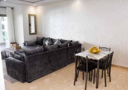 a living room with a couch and a table with chairs at Luxurious Apt with Pool&Sea View in Pont Blondin
